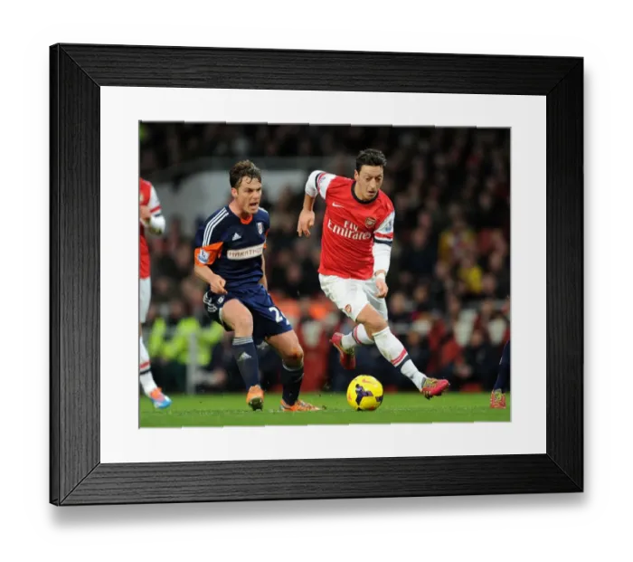Framed Print : Mesut Ozil vs. Scott Parker: A Premier League Face-Off at the Emirates