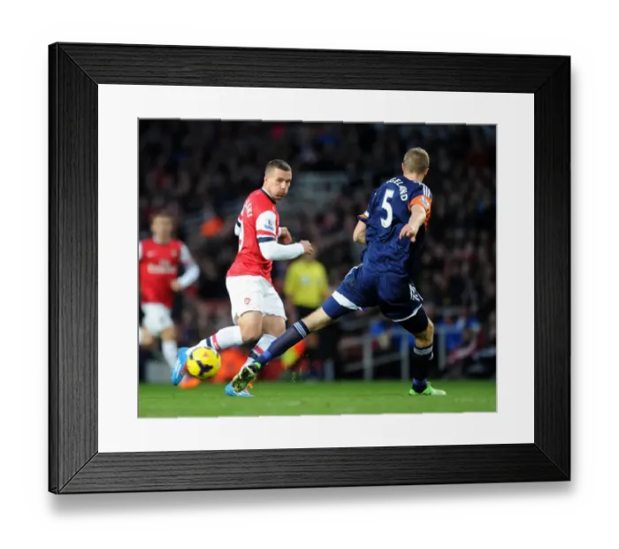 Framed Print : Arsenal's Lukas Podolski Clashes with Fulham's Brede Hangeland during the 2013-14 Premier League Match