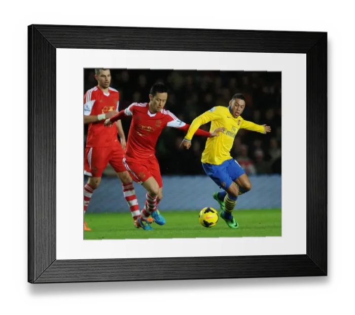 Framed Print : Arsenal's Alex Oxlade-Chamberlain Faces Off Against Southampton's Maya Yoshida in Premier League Clash Framed Print : Arsenal's Alex Oxlade-Chamberlain Faces Off Against Southampton's Maya Yoshida in Premier League Clash