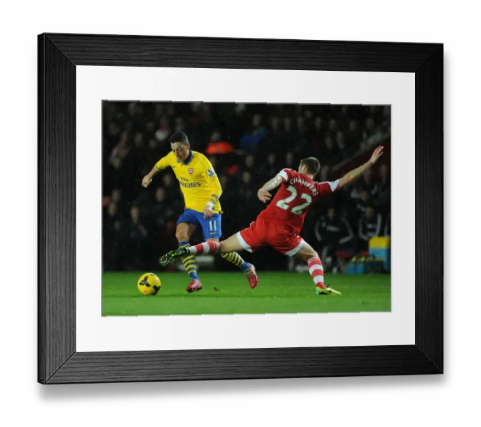Framed Print : Mesut Ozil vs Calum Chambers: Intense Battle at Southampton's St Marys Stadium (Arsenal vs Southampton, Premier League 2013-14) Framed Print : Mesut Ozil vs Calum Chambers: Intense Battle at Southampton's St Marys Stadium (Arsenal vs Southampton, Premier League 2013-14)