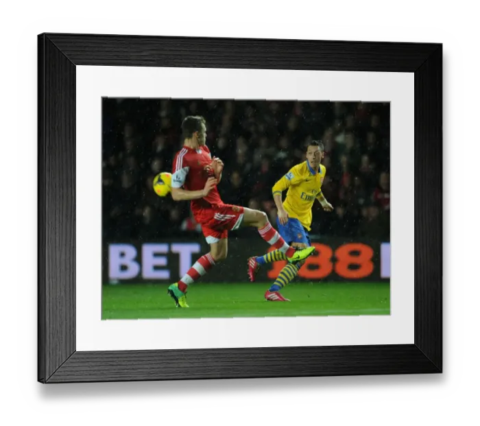 Framed Print : Mesut Ozil vs Calum Chambers: A Football Showdown at Southampton's St Marys Stadium (Arsenal vs Southampton 2013-14)