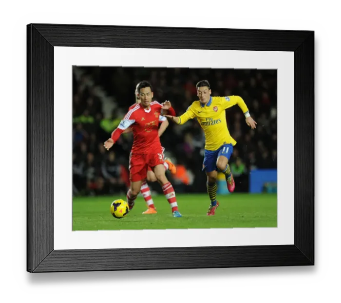 Framed Print : Mesut Ozil vs Maya Yoshida: Clash at St. Mary's - Southampton v Arsenal, Premier League 2013-14 Framed Print : Mesut Ozil vs Maya Yoshida: Clash at St. Mary's - Southampton v Arsenal, Premier League 2013-14