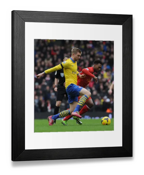 Framed Print : Per Mertesacker vs. Daniel Sturridge: Intense Battle at Anfield - Liverpool v Arsenal, Premier League 2013-14