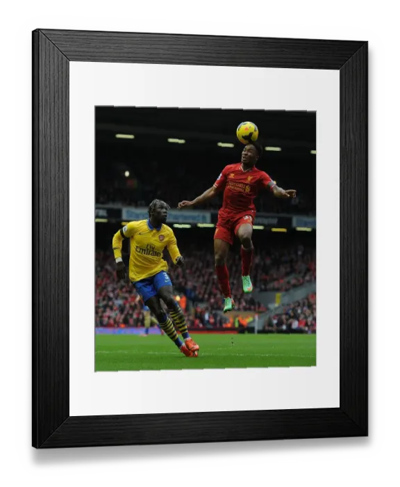 Framed Print : Sterling Soars Past Sagna: Intense Moment from the Liverpool vs. Arsenal Premier League Clash