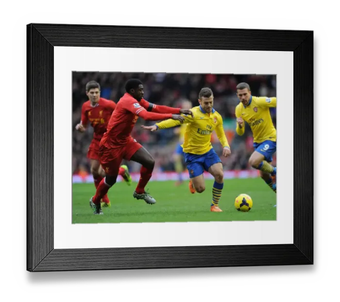 Framed Print : Jack Wilshere Outmaneuvers Kolo Toure: Intense Rivalry in the Premier League Clash between Arsenal and Liverpool