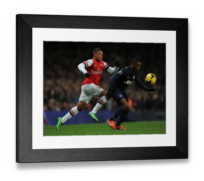 Framed Print : Arsenal's Alex Oxlade-Chamberlain Battles Manchester United's Patrice Evra Framed Print : Arsenal's Alex Oxlade-Chamberlain Battles Manchester United's Patrice Evra