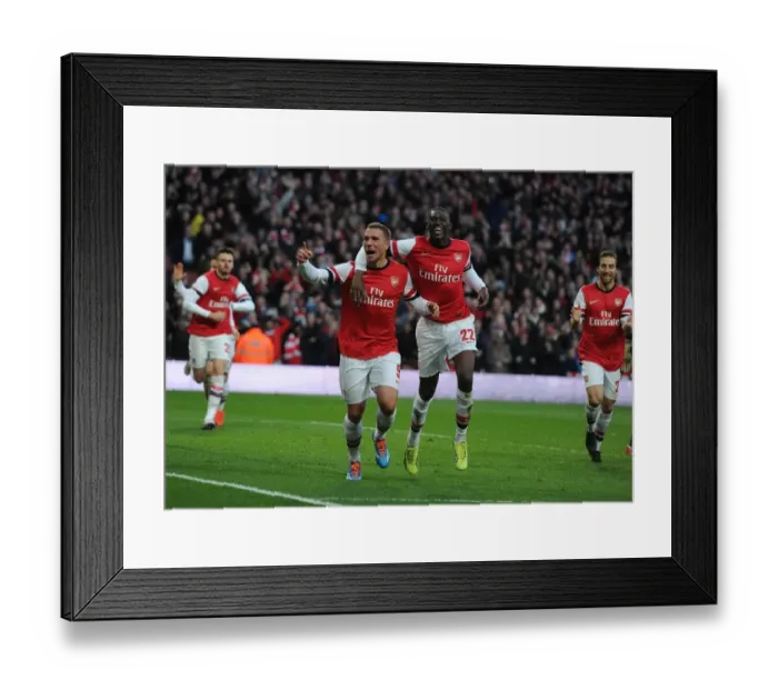 Framed Print : Arsenal Double Strike: Podolski and Sanogo Celebrate Goals Against Liverpool in FA Cup