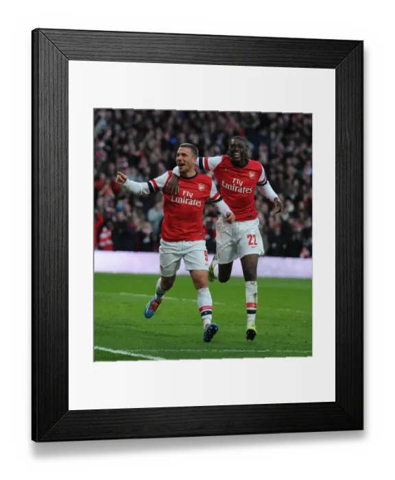 Framed Print : Arsenal's Podolski and Sanogo Celebrate Double Strike Against Liverpool in FA Cup Framed Print : Arsenal's Podolski and Sanogo Celebrate Double Strike Against Liverpool in FA Cup