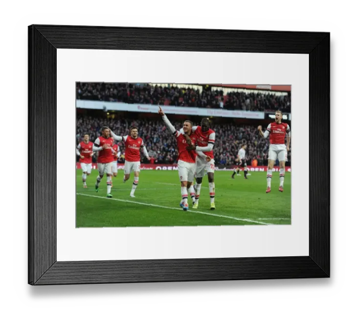 Framed Print : Arsenal Celebrate Double Strike: Podolski and Sanogo vs Liverpool (FA Cup 2013-14) Framed Print : Arsenal Celebrate Double Strike: Podolski and Sanogo vs Liverpool (FA Cup 2013-14)