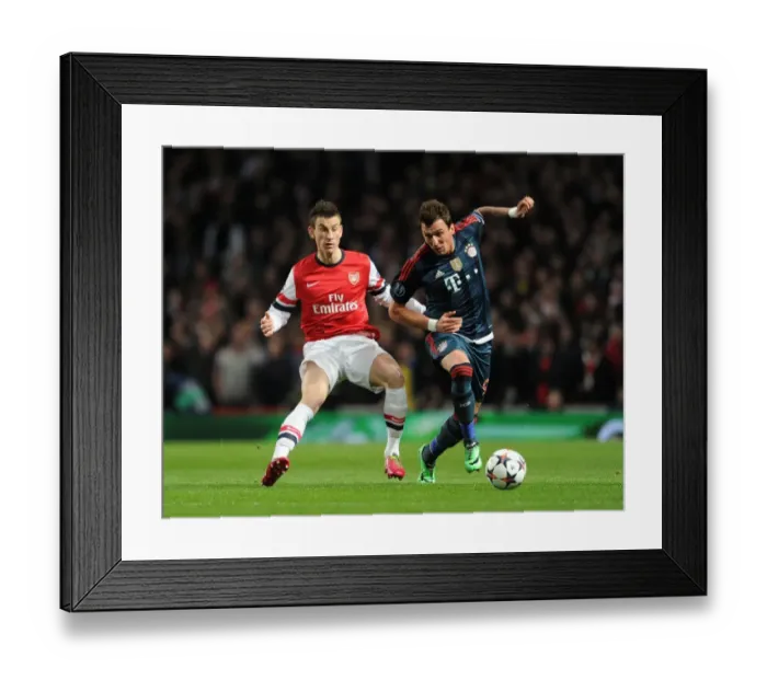 Framed Print : Arsenal vs. Bayern Munich: Koscielny vs. Mandzukic in Intense UEFA Champions League Clash