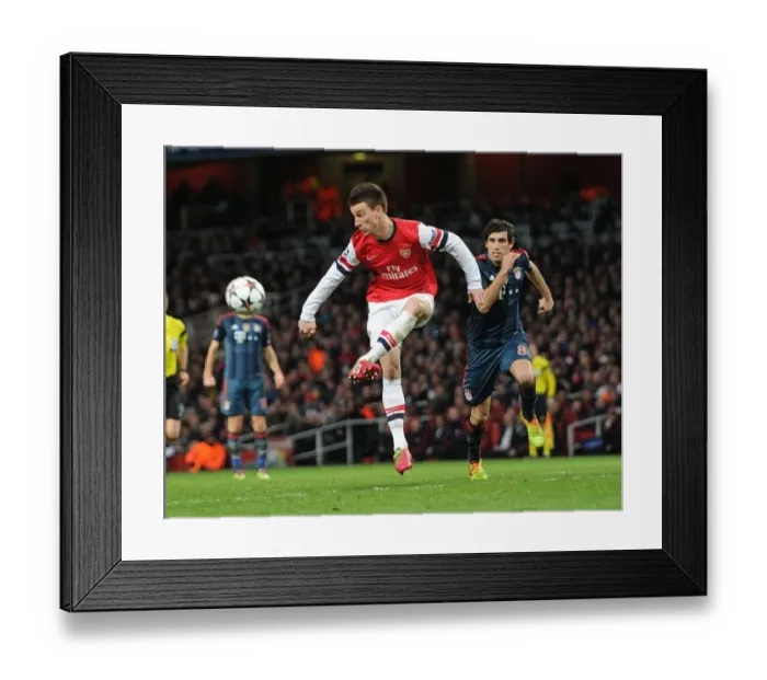 Framed Print : Arsenal's Laurent Koscielny Faces Off Against Bayern Munchen's Javi Martinez in Intense UCL Clash