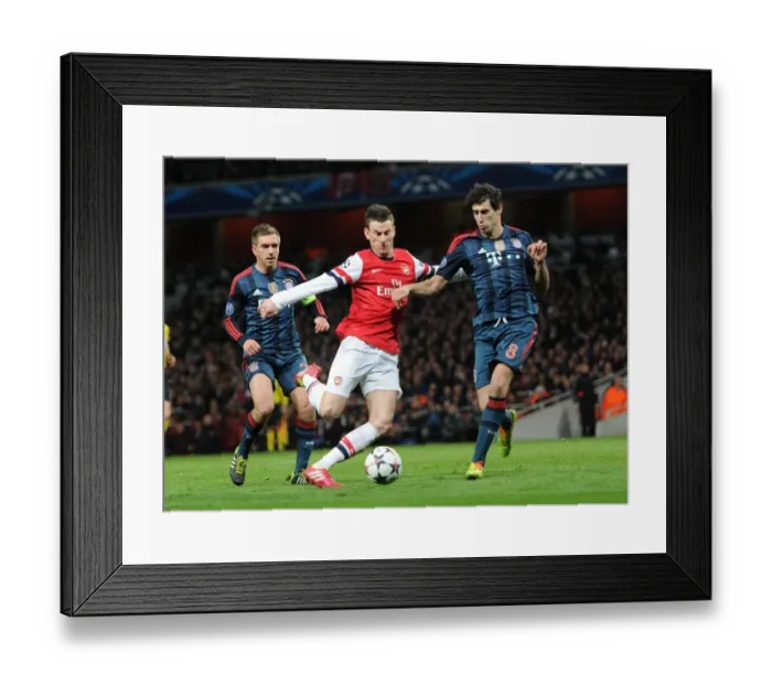 Framed Print : Showdown in the Champions League: Koscielny vs. Martinez - Arsenal's Defensive Battle against Bayern Munich Framed Print : Showdown in the Champions League: Koscielny vs. Martinez - Arsenal's Defensive Battle against Bayern Munich