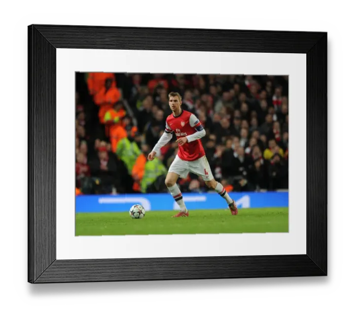 Framed Print : Per Mertesacker Focuses in Arsenal's UEFA Champions League Showdown against Bayern Munich