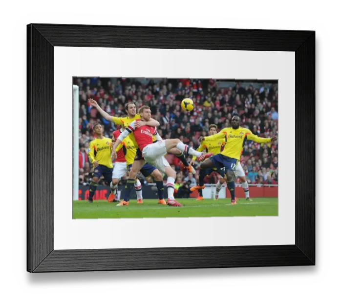 Framed Print : Arsenal vs Sunderland: Per Mertesacker Faces Off Against John O'Shea and Jozy Altidore Framed Print : Arsenal vs Sunderland: Per Mertesacker Faces Off Against John O'Shea and Jozy Altidore
