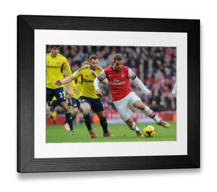 Framed Print : Intense Face-Off: Lukas Podolski vs. Phil Bardsley in Arsenal's Battle Against Sunderland