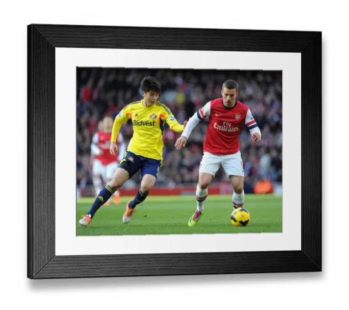 Framed Print : Intense Showdown: Podolski vs. Ki in Arsenal's Battle Against Sunderland