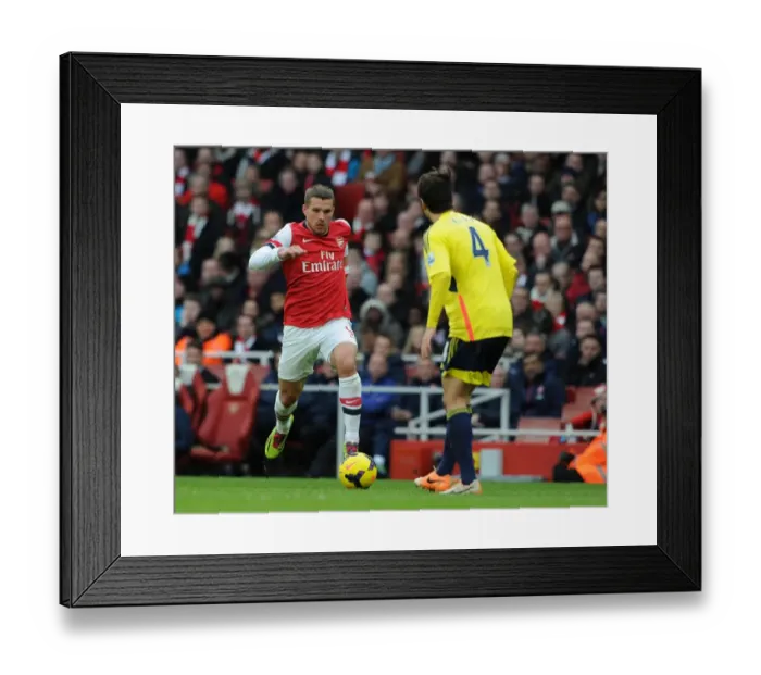 Framed Print : Arsenal's Podolski Takes On Sunderland's Ki in Premier League Clash