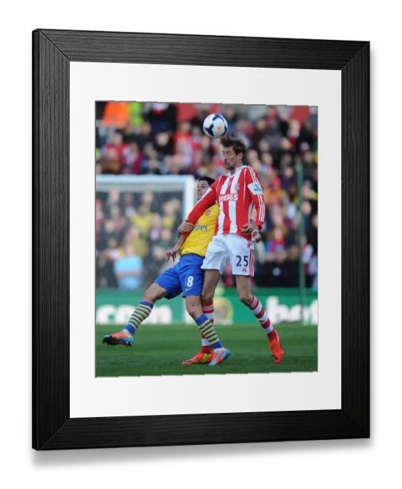 Framed Print : Mikel Arteta vs. Peter Crouch: Intense Clash in Stoke City vs. Arsenal (2013-14)