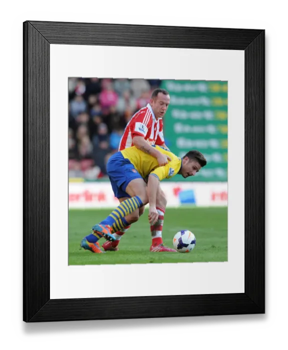 Framed Print : Giroud vs. Adam: Intense Battle in Stoke City vs. Arsenal Premier League Clash