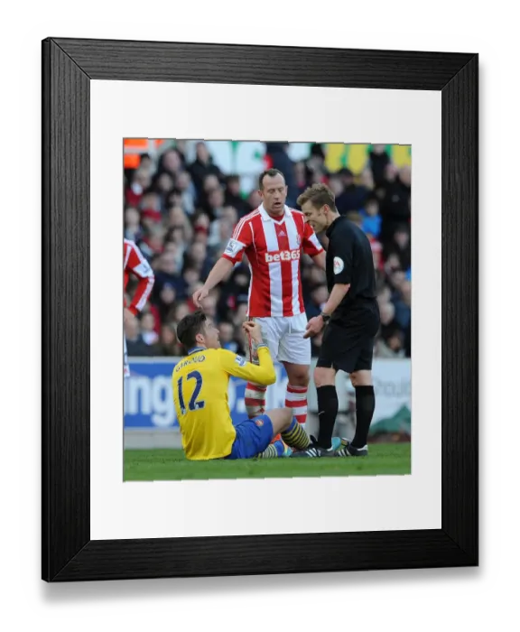Framed Print : Giroud vs. Adam: Controversial Clash between Stoke's Charlie Adam and Arsenal's Olivier Giroud during Premier League Match Framed Print : Giroud vs. Adam: Controversial Clash between Stoke's Charlie Adam and Arsenal's Olivier Giroud during Premier League Match