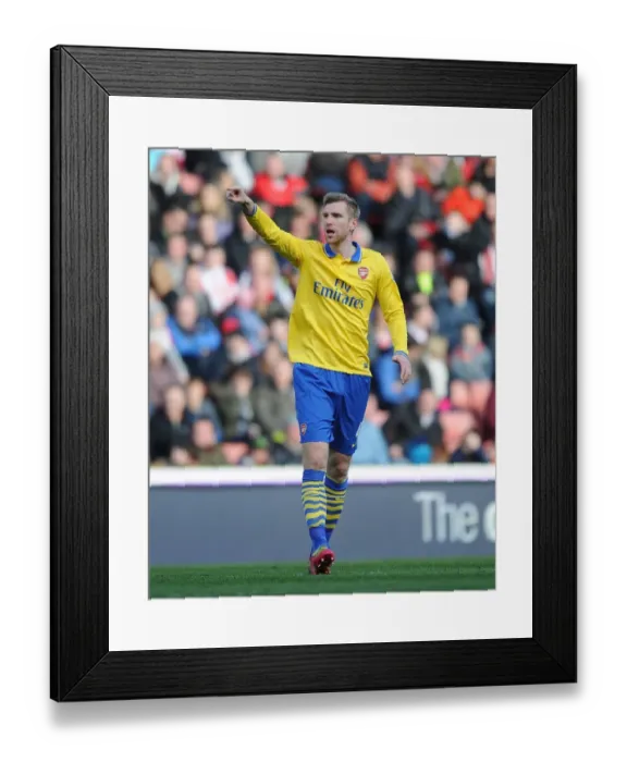 Framed Print : Per Mertesacker Focuses in Stoke City vs Arsenal Premier League Clash