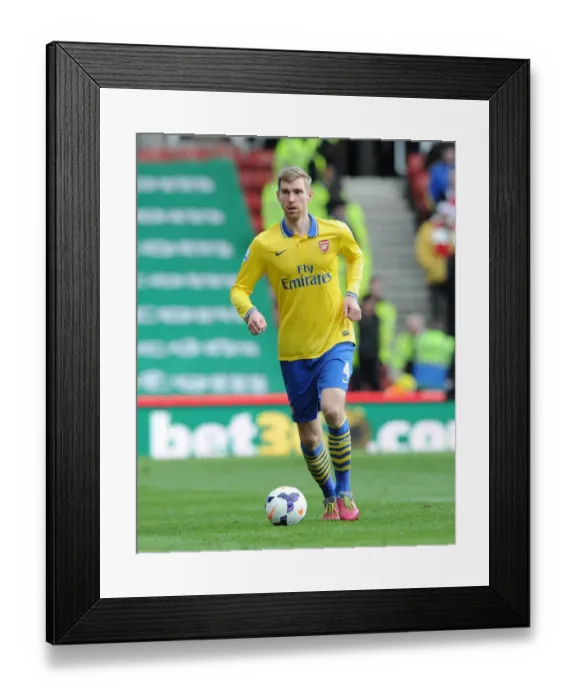 Framed Print : Per Mertesacker (Arsenal). Stoke City 1: 0 Arsenal. Barclays Premier League. The Britainna Stadium