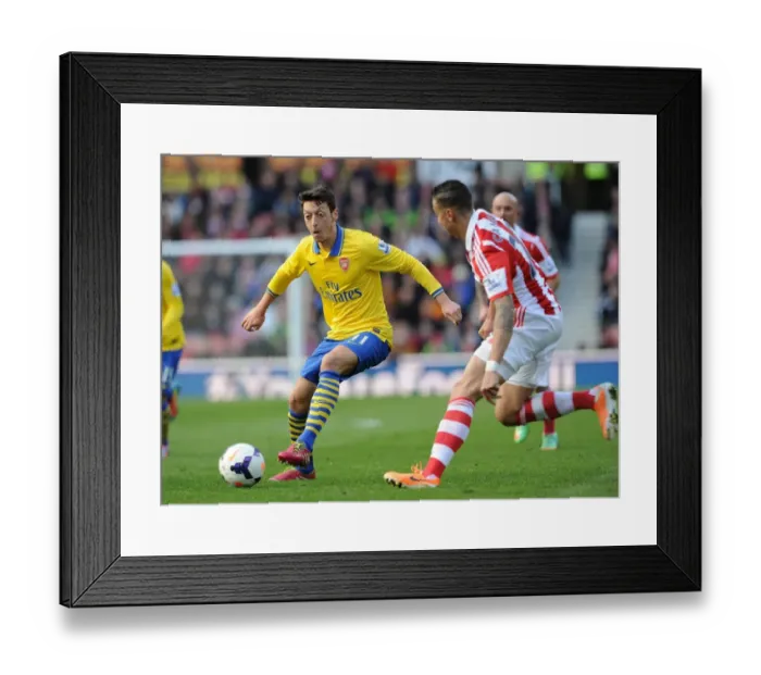 Framed Print : Mesut Ozil vs. Geoff Cameron: Clash at Britannia Stadium - Stoke City vs. Arsenal, Premier League 2013-14 Framed Print : Mesut Ozil vs. Geoff Cameron: Clash at Britannia Stadium - Stoke City vs. Arsenal, Premier League 2013-14