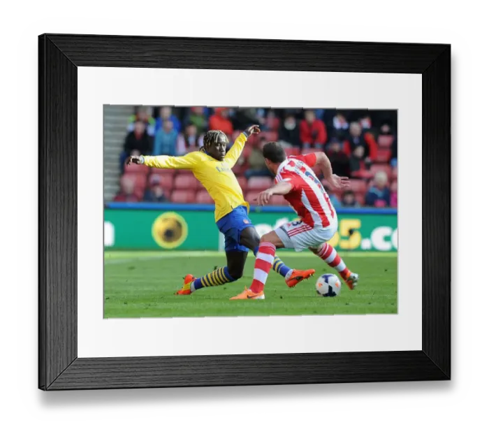 Framed Print : Sagna vs Pieters: Intense Tackle in Stoke City vs Arsenal Premier League Clash Framed Print : Sagna vs Pieters: Intense Tackle in Stoke City vs Arsenal Premier League Clash