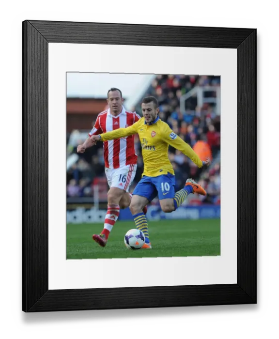 Framed Print : Jack Wilshere vs. Charlie Adam: Clash of Midfield Titans - Stoke City vs. Arsenal, Premier League, 2014