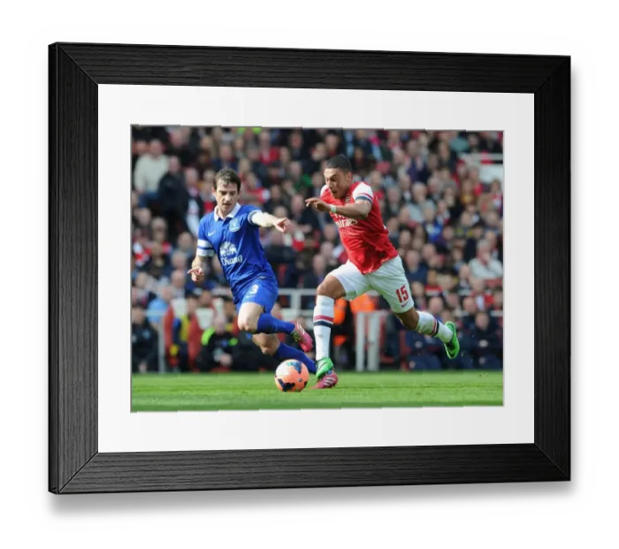 Framed Print : Arsenal's Alex Oxlade-Chamberlain Faces Off Against Everton's Leighton Baines in FA Cup Quarter-Final Framed Print : Arsenal's Alex Oxlade-Chamberlain Faces Off Against Everton's Leighton Baines in FA Cup Quarter-Final