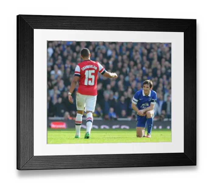 Framed Print : Arsenal's Oxlade-Chamberlain Offers A Hand to Everton's Baines in FA Cup Quarter-Final