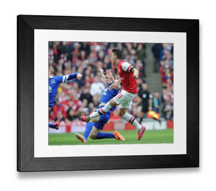 Framed Print : Mesut Ozil score Arsenals 1st goal past Seamus Coleman (Everton). Arsenal 4: 1 Everton Framed Print : Mesut Ozil score Arsenals 1st goal past Seamus Coleman (Everton). Arsenal 4: 1 Everton