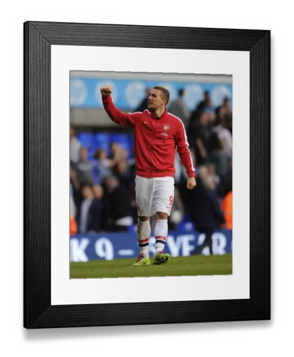 Framed Print : Podolski's Euphoria: Arsenal's Thrilling Victory over Tottenham in the Premier League, 2014