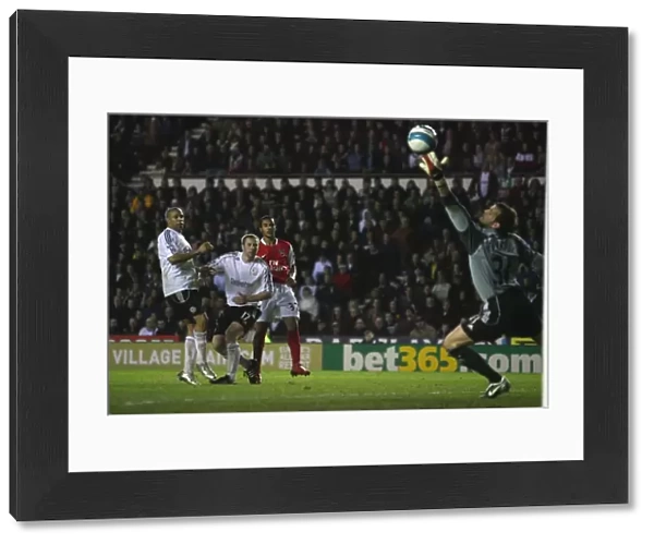 Theo Walcott shoots past Derby goalkeeper Roy Carroll to score the 4th Arsenal goal