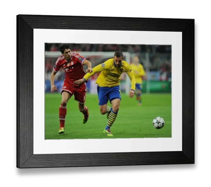 Framed Print : Lukas Podolski vs. Javi Martinez: Battle in the UEFA Champions League between FC Bayern Munich and Arsenal