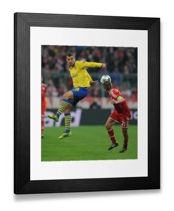 Framed Print : Clash of Titans: Lukas Podolski vs. Philipp Lahm - FC Bayern Munich vs. Arsenal, UEFA Champions League