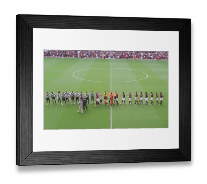 Framed Print : The Arsenal and Newcastle team shake hands before the match