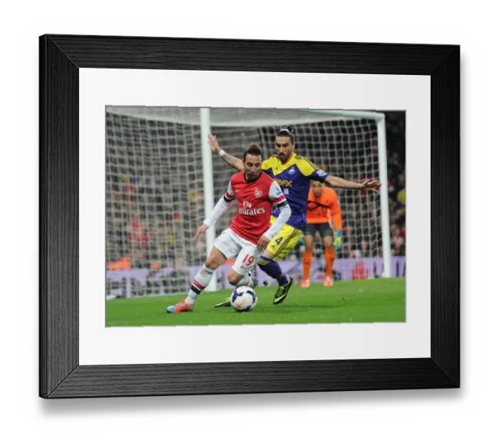 Framed Print : Arsenal's Santi Cazorla Fends Off Swansea's Chico Flores in Premier League Clash