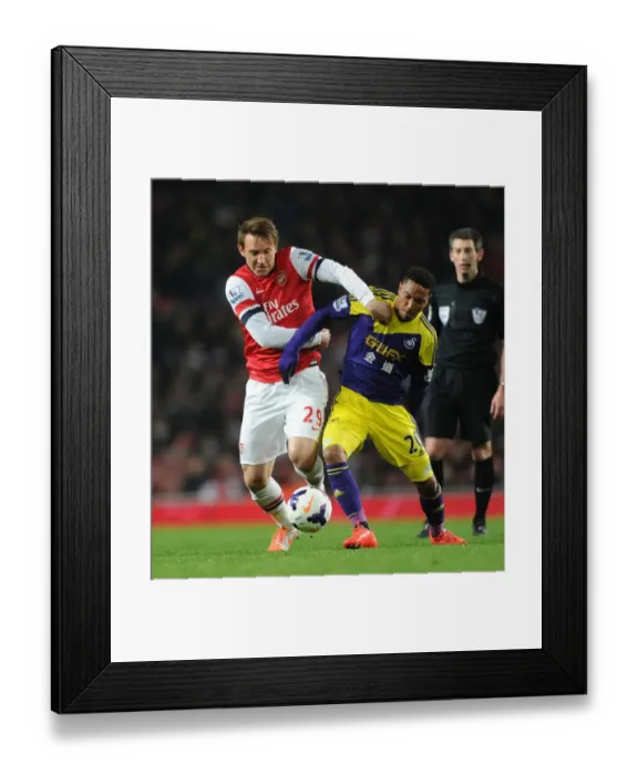 Framed Print : Arsenal vs Swansea: Kallstrom vs De Guzman - Intense Battle in the Premier League