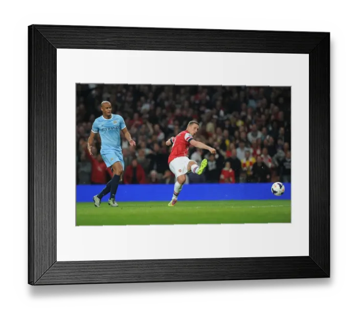 Framed Print : Arsenal's Lukas Podolski Outmaneuvers Manchester City's Vincent Kompany in the 2013 / 14 Premier League Clash Framed Print : Arsenal's Lukas Podolski Outmaneuvers Manchester City's Vincent Kompany in the 2013 / 14 Premier League Clash