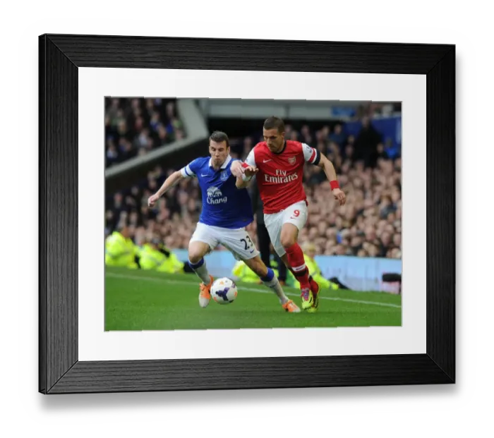Framed Print : Podolski vs. Coleman: A Premier League Showdown at Goodison Park