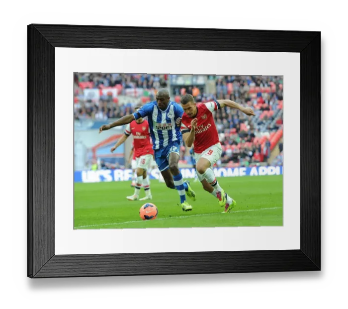 Framed Print : Arsenal's Lukas Podolski Faces Off Against Wigan's Emerson Boyce in FA Cup Semi-Final Showdown Framed Print : Arsenal's Lukas Podolski Faces Off Against Wigan's Emerson Boyce in FA Cup Semi-Final Showdown