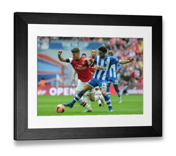Framed Print : Arsenal's Aaron Ramsey vs. Wigan's Jordi Gomez: A FA Cup Semi-Final Battle Framed Print : Arsenal's Aaron Ramsey vs. Wigan's Jordi Gomez: A FA Cup Semi-Final Battle