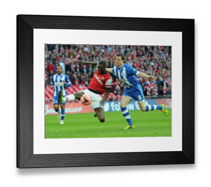 Framed Print : Arsenal's Yaya Sanogo Faces Off Against Wigan's Gary Cadwell in FA Cup Semi-Final Showdown Framed Print : Arsenal's Yaya Sanogo Faces Off Against Wigan's Gary Cadwell in FA Cup Semi-Final Showdown