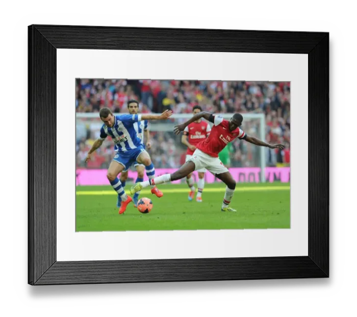 Framed Print : Arsenal's Yaya Sanogo Faces Off Against Wigan's James McArthur in FA Cup Semi-Final Showdown