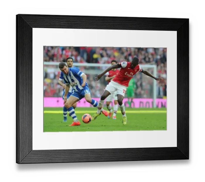 Framed Print : Arsenal's Yaya Sanogo vs. Wigan's James McArthur: A FA Cup Semi-Final Battle Framed Print : Arsenal's Yaya Sanogo vs. Wigan's James McArthur: A FA Cup Semi-Final Battle