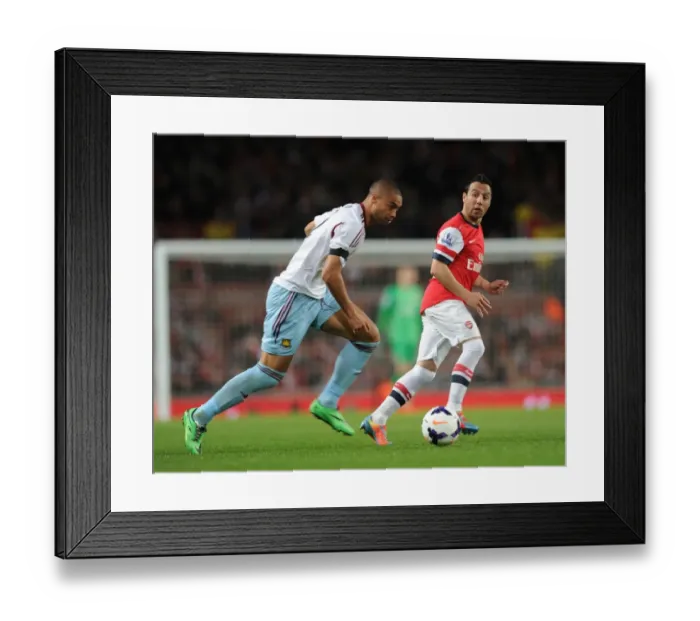 Framed Print : Arsenal's Santi Cazorla Evades Winston Reid's Pressure during Arsenal v West Ham United (2013 / 14)