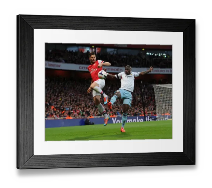 Framed Print : Olivier Giroud (Arsenal) Guy Demel (West Ham). Arsenal 3: 1 West Ham United. Barclays Premier League Framed Print : Olivier Giroud (Arsenal) Guy Demel (West Ham). Arsenal 3: 1 West Ham United. Barclays Premier League