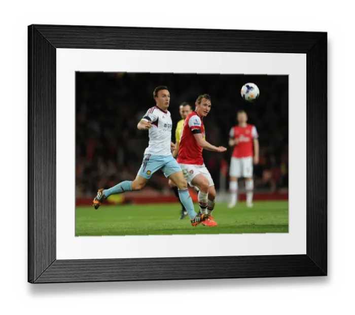 Framed Print : Arsenal's Kim Kallstrom Faces Mark Noble Pressure in Premier League Clash (2013 / 14)