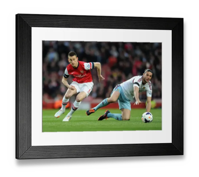 Framed Print : Arsenal's Koscielny Brushes Off Andy Carroll's Challenge During Arsenal v West Ham United (2013 / 14)